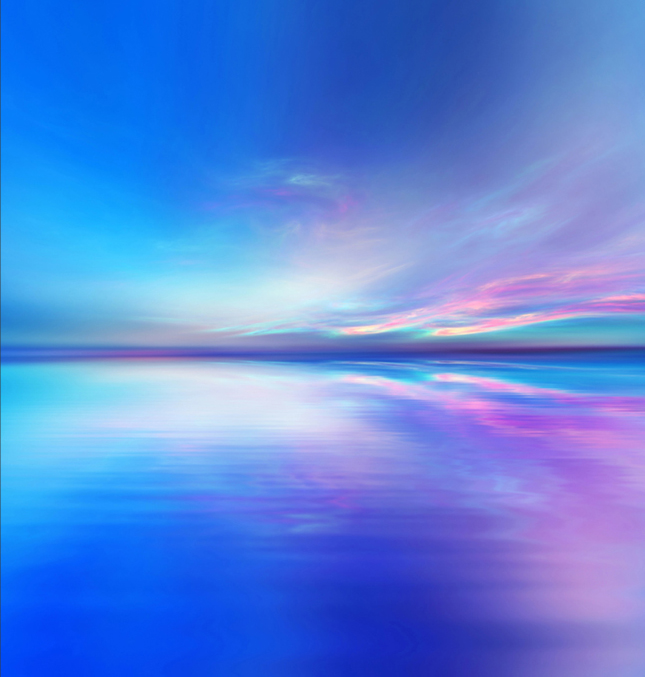 Abstract ocean scene with an incredible purple, pink, orange and blue sunset reflected in a vast ocean stretching off into the distance.